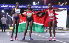 Kenya's Ruth Chepngetich (C) celebrates winning gold with Bahrain's Rose Chelimo (R) in silver and Namibia's Helalia Johannes in bronze after the Women's Marathon at the 2019 IAAF World Athletics Championships in Doha on 28 September 2019. Picture: AFP