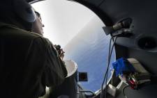 FILE: A French soldier aboard an aircraft looking out a window during searches for debris from the crashed EgyptAir flight MS804 over the Mediterranean Sea. Picture: AFP.