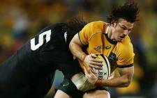 Rob Horne of the Wallabies is tackled during The Rugby Championship match between the Australian Wallabies and the New Zealand All Blacks on 16 August 2014. Picture: Facebook.