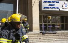 A firefighter sits in front of the Bank of Lisbon building where 3 of his colleagues died while trying to extinguish a fire.  Picture: Christa Eybers/EWN