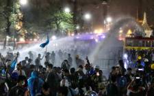 Police use water cannons on pro-democracy protesters to disperse them during an anti-government demonstration in Bangkok on 8 November 2020. Picture: AFP