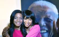 British actress Naomie Harris poses with Mandela's daughter Zindzi near a poster of Nelson Mandela on November 2, 2013. Picture: AFP