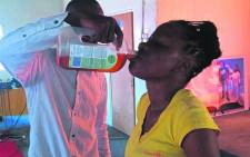 A screengrab showing Prophet Rufus Phala giving one of his church members Dettol. Picture: Facebook.com.