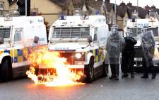 Flames lick up the front of a police vehicle as police officers are attacked by nationalist youths in the Springfield Road area of Belfast on April 8, 2021 following days of loyalist violence. Picture: Paul Faith/AFP