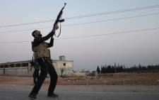 A Turkish-backed Syrian rebel fires off his gun in the north-western border town of al-Bab on 23 February 2017 after they fully captured the town from the Islamic State. Picture: AFP.