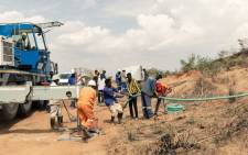 Rescue workers busy at work installing a water pump to drain water from a mine shaft so that they can gain access to at least 40 informal gold miners trapped inside a collapsed shaft at Ran Mine in Bindura, on 26 November 2020. Picture: AFP