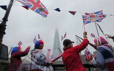 Royal supporters gather beside the River Thames in London, on June 3, 2012, as Britain celebrates the Queen's Diamond Jubilee River Pageant. Picture: AFP