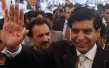 Pakistan's new Prime Minister Raja Pervez Ashraf gestures as he arrives at the coalition party headquarters of MQM in Karachi. Picture: AFP