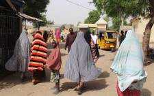 FILE: Residents are seen walking in Maiduguri, northeastern Nigeria on 7 April 2019, a day after a double suicide attack, that killed at least three people and wounded more than 30. At least three people were killed and more than 30 wounded in a double suicide attack in Maiduguri, the capital of northeastern Nigeria, ravaged by the insurgency of the jihadist group Boko Haram, according to security sources and residents on 7 April  2019. Picture: AFP