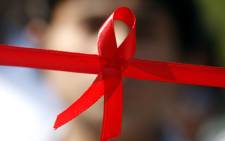 A red ribbon, the internationally known symbol of AIDS awareness.