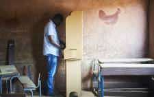 A man prepares to vote a polling station in Bamako on 12 August, 2018 during the second round of Mali's presidential elections. Picture: AFP