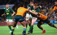 Australia's Samu Kerevi(L) tackles South Africa's Steven Kitshoff during the rugby Championship match at the Suncorp Stadium in Brisbane on 18 September 2021. Picture: AFP