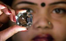 An Indian model shows the replica of the famous Indian diamond Koh-i-noor. Picture: AFP.