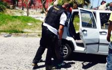 FILE: Cape Town police officers search suspects in Manenberg after gang warfare flares up on the Cape flats. Picture: Shamiela Fisher/EWN