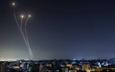 A streak of light appears as Israel's Iron Dome anti-missile system intercepts rockets launched from the Gaza Strip, early on May 17, 2021, Israeli warplanes bombarded the Gaza Strip overnight, said witnesses in the Palestinian enclave, from where armed groups have launched rockets into the Jewish state. Picture: Mahmud Hams / AFP