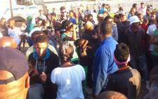Hundreds of disgruntled Macassar residents gathered near the police station threatening to vandalise more public property. Picture: Mia Spies