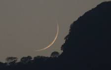 The new Crescent moon is seen above the Margala Hills to mark the beginning of the of the Islamic holy month of Ramadaan in Islamabad on 6 June 2016. Picture: Aamir Qureshi/AFP.