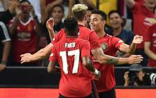 Manchester United's Mason Greenwood (back R) is congratulated by teammates after scoring during the International Champions Cup football match between Manchester United and Inter Milan in Singapore on 20 July 2019. Picture: AFP.
