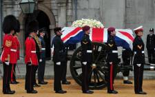 The Bearer Party made up of personnel from the three branches of the military stand alongside the coffin of British former prime minister Margaret Thatcher on a gun carriage to be drawn by the King's Troop Royal Horse Artillery during her ceremonial funeral at the Church of St Clement Danes in central London on April 17, 2013.  Picture: AFP.