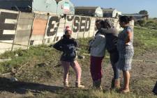 Family members of Heinrich Carolus pictured at the scene where his body was found next to a railway line in Blackheath. Picture: Lauren Isaacs/EWN