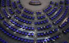 Workers arrange material as they prepare for Tuesday's first parliamentary session of Germany's newly-elected parliament in the Reichstag building housing the Bundestag (lower house of parliament) in Berlin on 25 October 2021. Picture: AFP