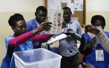 A polling station official shows a ballot during the counting of votes at the end of the general election in Luanda on 23 August 2017. Picture: AFP.