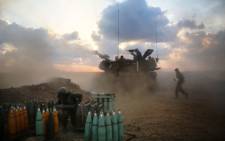 FILE: Israeli soldiers fire towards the Gaza Strip from their position near Israel's border with the coastal Palestinian enclave on 19 July 2014. Picture: AFP.