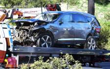 A tow truck recovers the vehicle driven by golfer Tiger Woods in Rancho Palos Verdes, California, on 23 February 2021, after a rollover accident. Picture: AFP