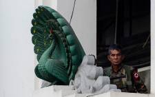 A soldier stands guard in City Hall in Yangon on 1 February 2021, after Myanmar's military seized power in a bloodless coup on Monday, detaining democratically elected leader Aung San Suu Kyi as it imposed a one-year state of emergency. Picture: AFP