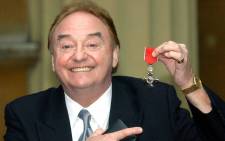 In this file photo taken in December 2003, sixties singing sensation Gerry Marsden, from Liverpool, poses with his MBE for services to Liverpudlian Charities at Buckingham Palace in London. Picture: AFP.