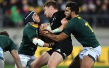 New Zealand's Jordie Barrett (C) is tackled by South Africa's Cheslin Kolbe and Damian de Allende (R) during their Rugby Championship match at the Westpac Stadium in Wellington on 15 September, 2018. Picture: AFP