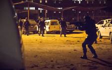 Police and the army raided the Madala hostel in Alexandra just before midnight on 22 April 2015. The move comes in a bid to quell xenophobic violence. Picture: Thomas Holder/EWN