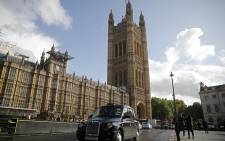 FILE: A black London taxi cab is drivens past the Houses of Parliament in central London on September 24, 2019 after the judgement of the court on the legality of Boris Johnson's advice to the Queen to suspend parliament for more than a month, as the clock ticks down to Britain's October 31 EU exit date. Picture: AFP