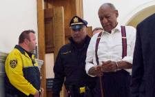 Comedian Bill Cosby is taken into custody in handcuffs at Montgomery County Courthouse 25 September, 2018 in Norristown, Pennsylvania, after being sentenced to at least three years in prison and branded a 'sexually violent predator' for assaulting a woman at his Philadelphia mansion 14 years ago. Picture: AFP