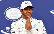 FILE: Mercedes' British driver Lewis Hamilton celebrates winning the pole position after the qualifying session at the Autodromo Nazionale circuit in Monza on 2 September 2017 ahead of the Italian Formula One Grand Prix. Picture: AFP.