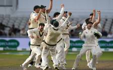 Australia's players celebrate their victory on the field after getting a positive review for the final wicket of England's Craig Overton on day five of the fourth Ashes cricket Test match between England and Australia at Old Trafford in Manchester, north-west England on 8 September 2019. Picture: AFP