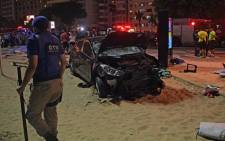 The scene of a car crash pictured at Copacabana beach in Rio de Janeiro on 18 January, 2018. Picture: AFP.