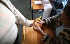 A Langa resident gets her thumb marked before casting her vote on 8 May 2019. Picture: Bertram Malgas/EWN