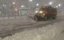A snow truck clears up snow on a US street during a blizzard. Picture: CNN