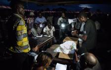 FILE: Improvised electoral agents count the ballots after a symbolic vote on 30 December 2018, at Kalinda Stadium in Beni, where voting was postponed for Democratic Republic of Congo's general elections. Picture: AFP