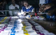 Independent National Electoral Commission (CENI) agents count votes during an electricity cut while watched by observers at Kiwele college in Lubumbashi on 30 December 2018, following the close of polls in the country's presidential, provincial and national elections. Picture: AFP