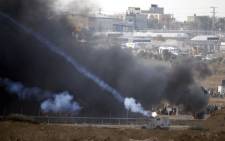 A picture taken from the southern Israeli kibbutz of Nahal Oz across the border with the Gaza Strip shows Israeli forces firing tear gas towards Palestinian protesters during clashes on 5 October 2018. Picture: AFP
