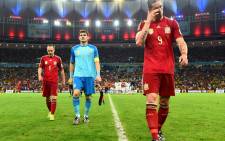 Spain's Andre Iniesta, Spain captain and goalkeeper Iker Casillas and Fernando Torres walk out of the field after they lost to Chile in the 2014 Fifa World Cup on 18 June 2014. Picture: Fifa.com.
