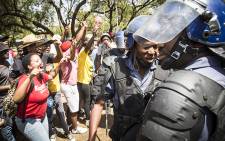 Police negotiated with UFS students to disperse after they vandalised a statue of apartheid era leader CR Swart. Picture: Reinart Toerien/EWN.