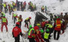 A handout picture released on January 21, 2017 by the Corpo Nazionale Soccorso Alpino e Speleologico (CNSAS) shows a rescuers digging at the avalanche-hit Hotel Rigopiano, near the village of Farindola, on the eastern lower slopes of the Gran Sasso mountain. Italian rescuers pulled four survivors from the hotel and said they remained hopeful of finding alive at least some of the 23 people still trapped under the ruins. Picture: CNSAS/AFP.