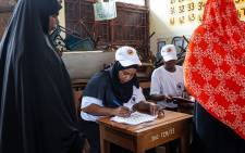 A Tanzanian electoral official checks the voter's roll at a polling station in the outskirts of Stone Town, Zanzibar, on 28 October 2020. Picture: AFP