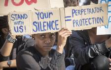 FILE: A UCT student holds up a poster during a protest against rape and sexual abuse on campus on 11 May 2016. Picture: Thomas Holder/EWN