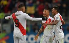 (L-R) Peru's Paolo Guerrero, Yoshimar Yotun and Christofer Gonzales celebrate after defeating Chile 3-0 in their Copa America football tournament semifinal match at the Gremio Arena in Porto Alegre, Brazil, on 3 July 2019. Picture: AFP