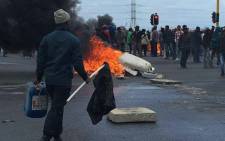 FILE: Disgruntled Lwandle residents gathering near burning tyres and rubbles on the N2 near Strand on 25 September. Picture: Ilze-Marie Le Roux/EWN