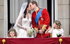 Britain's Prince William kisses his wife Kate, Duchess of Cambridge, on the balcony of Buckingham Palace, after the wedding service, on April 29, 2011, in London. Picture: AFP